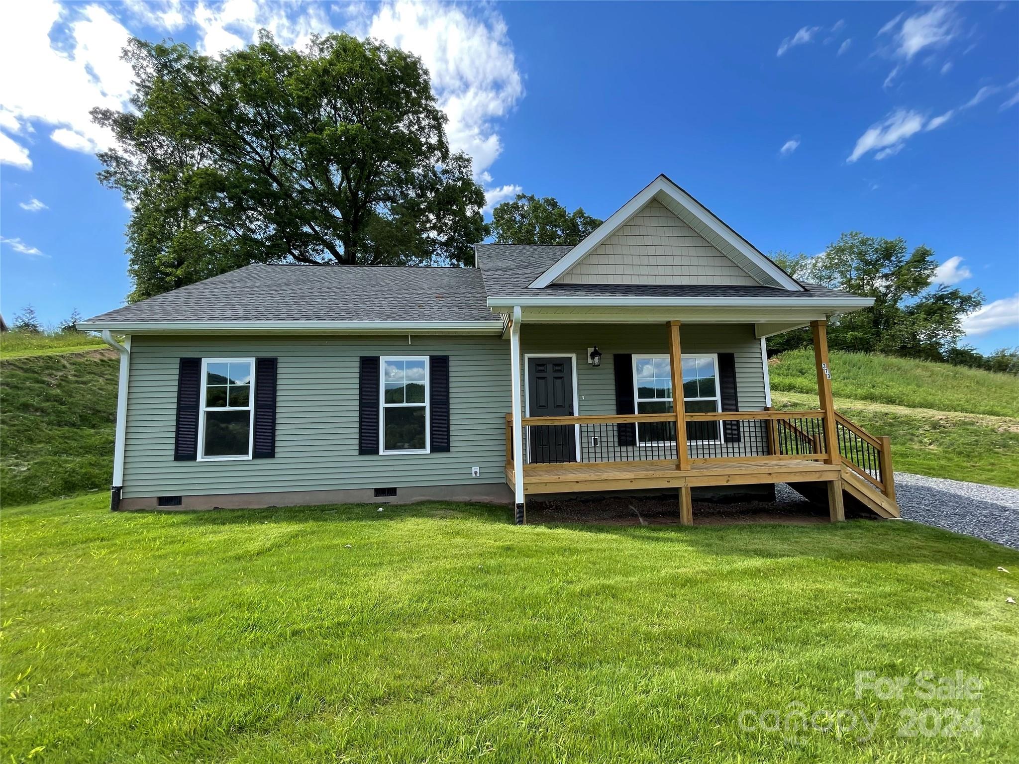 a view of house with yard and porch