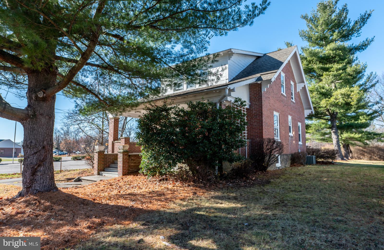 a view of a house with a tree in the yard