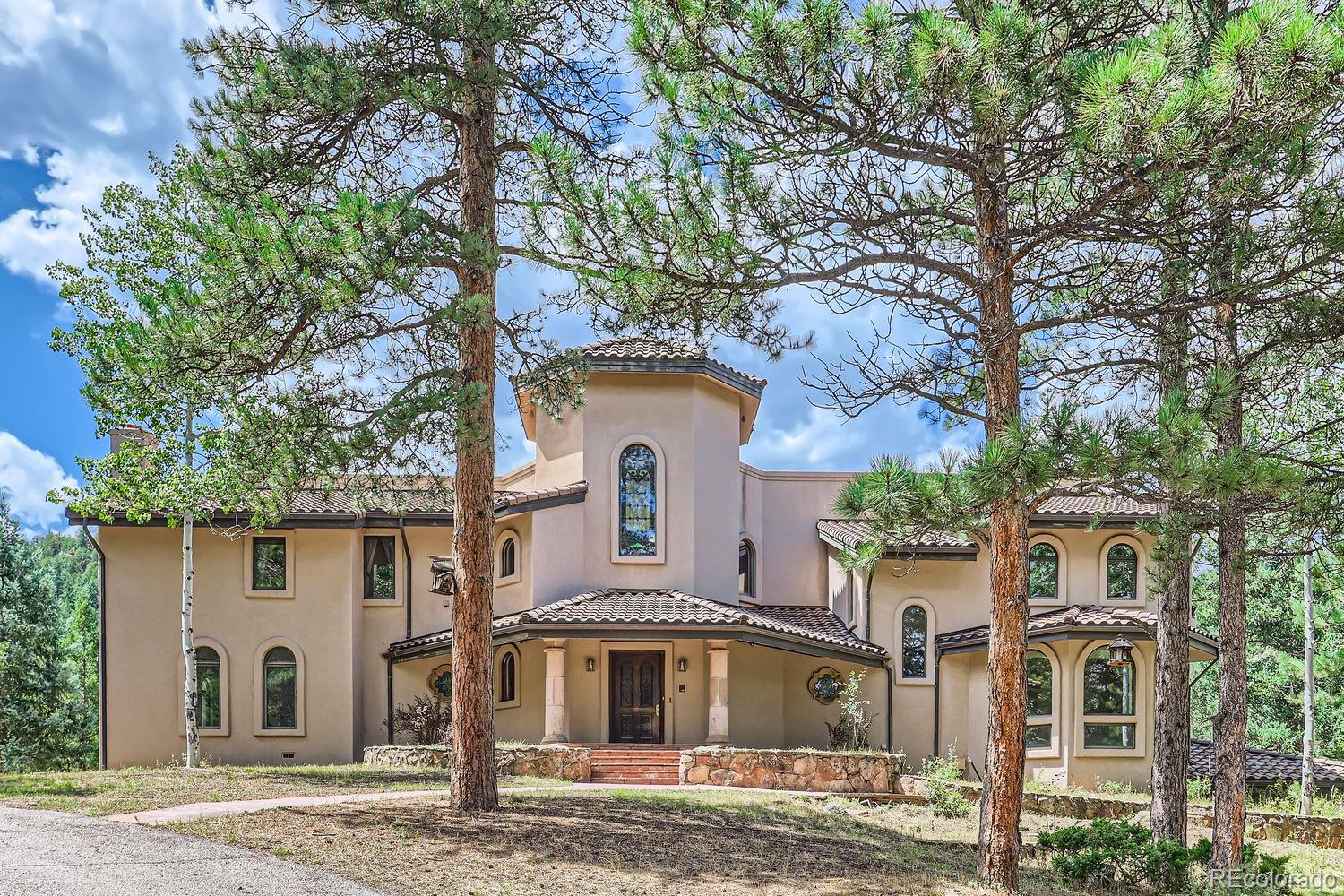 a front view of a house with a tree