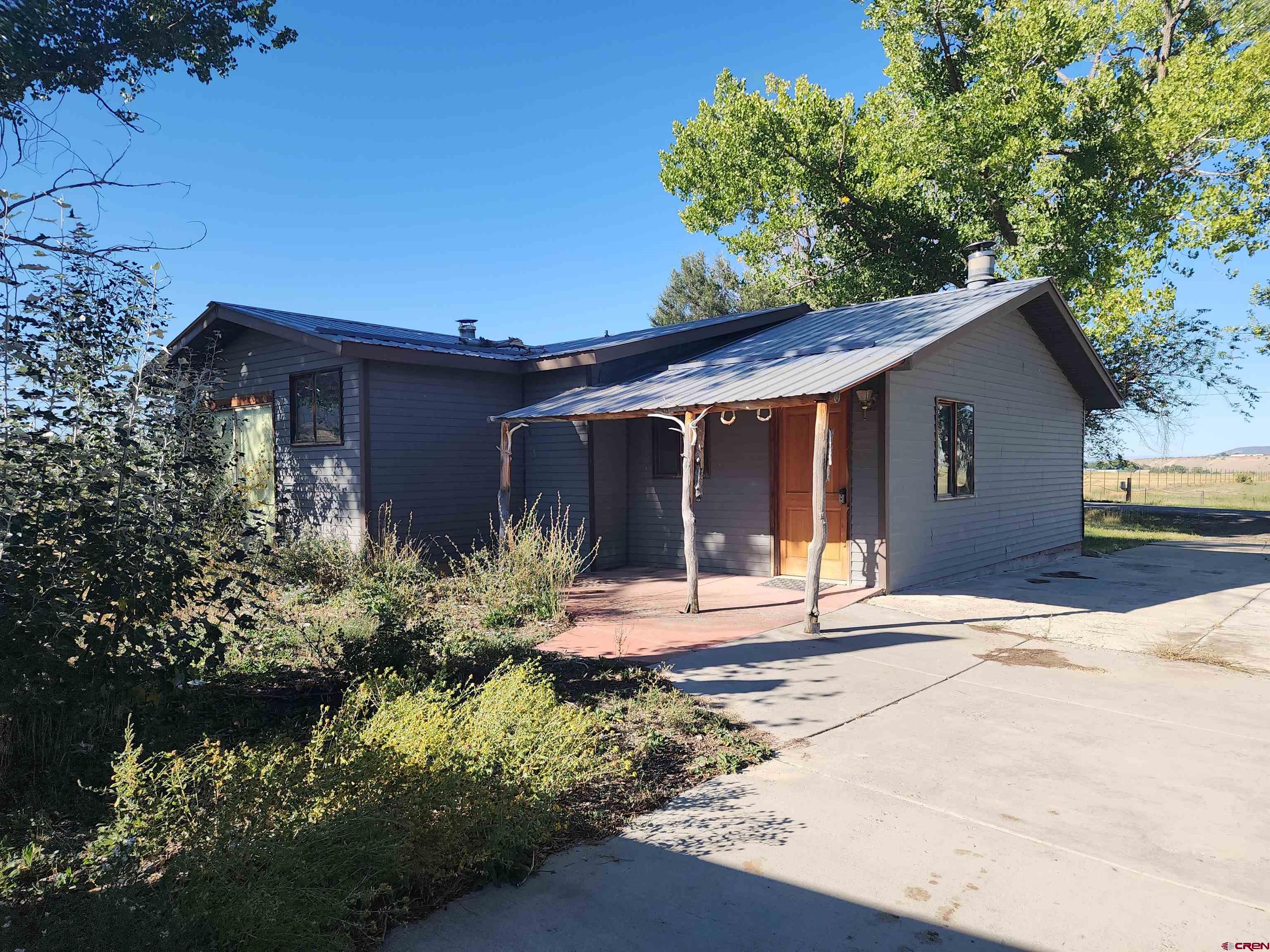 a front view of a house with a yard garage and outdoor seating