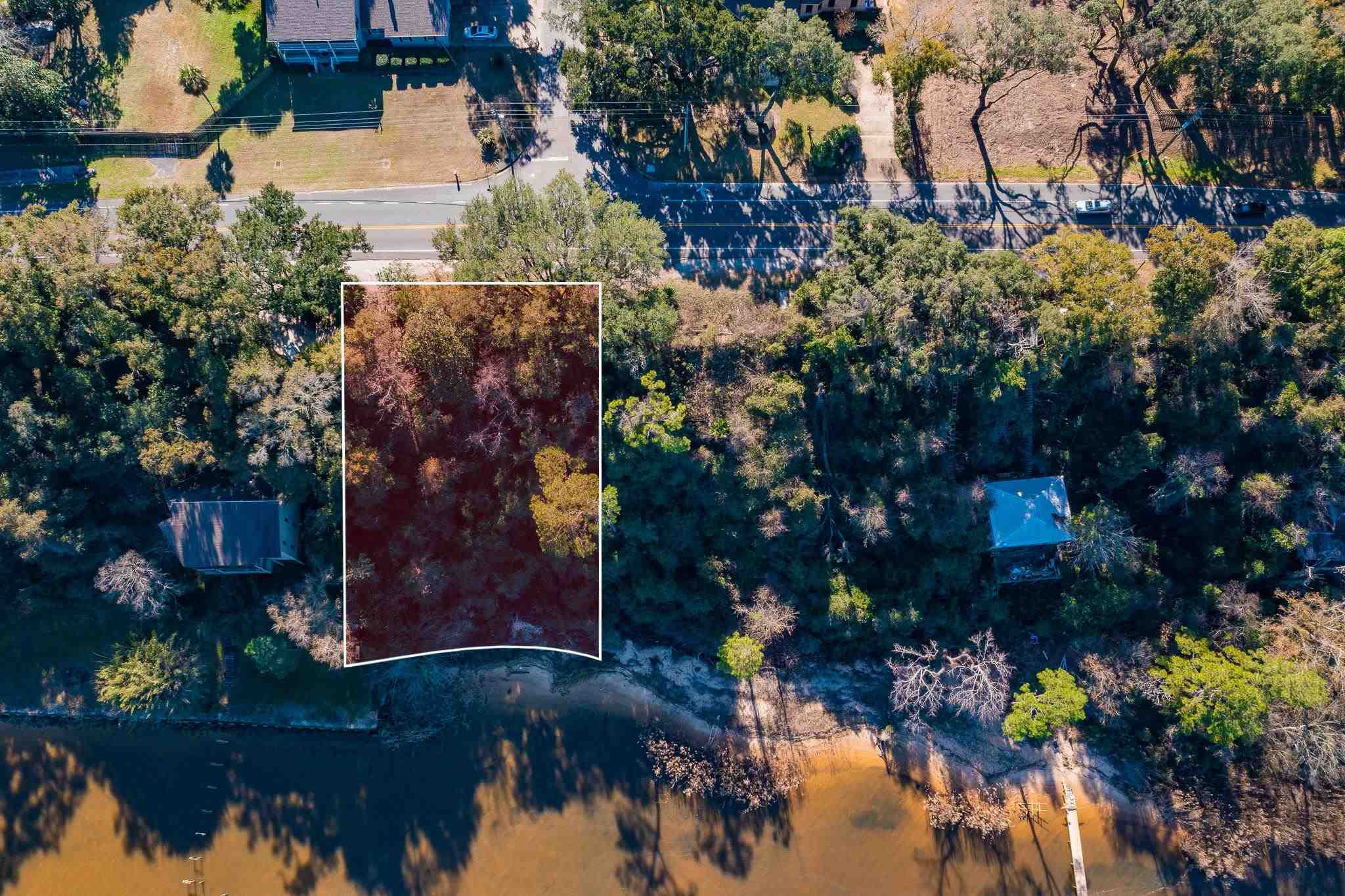 an aerial view of lake and residential houses with outdoor space