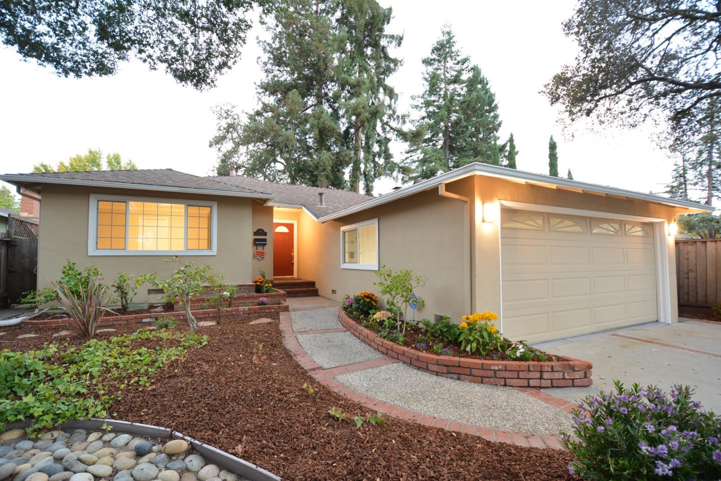 a backyard of a house with yard and outdoor seating