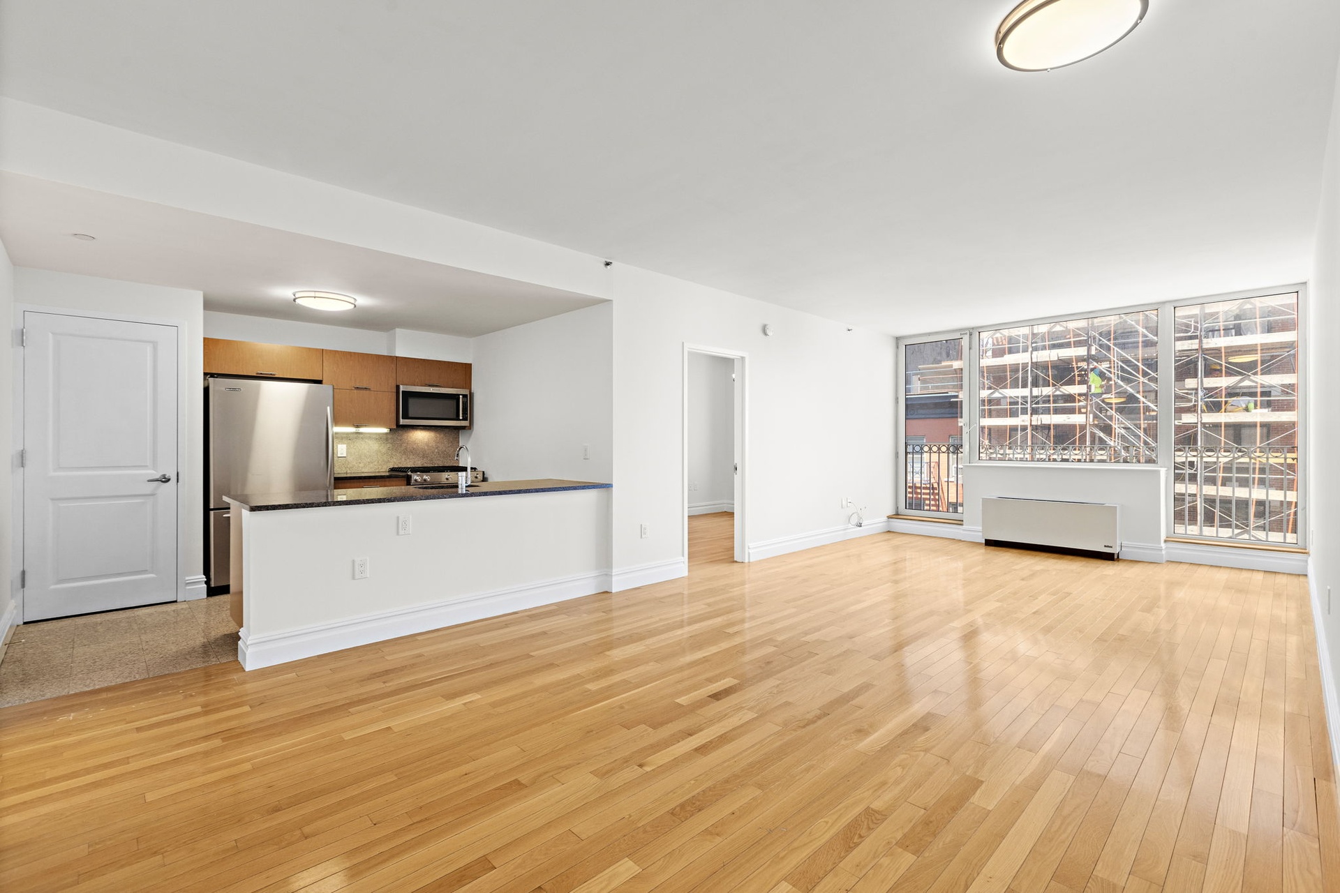 a view of kitchen with kitchen island wooden floor and center island