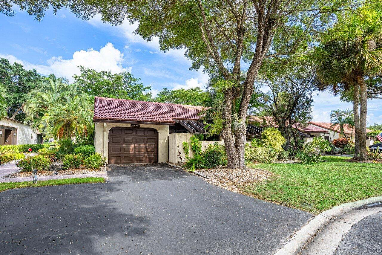 a front view of a house with a garden