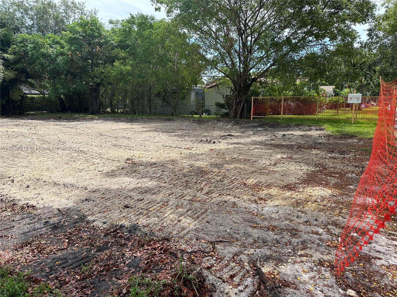 a view of a backyard with large trees