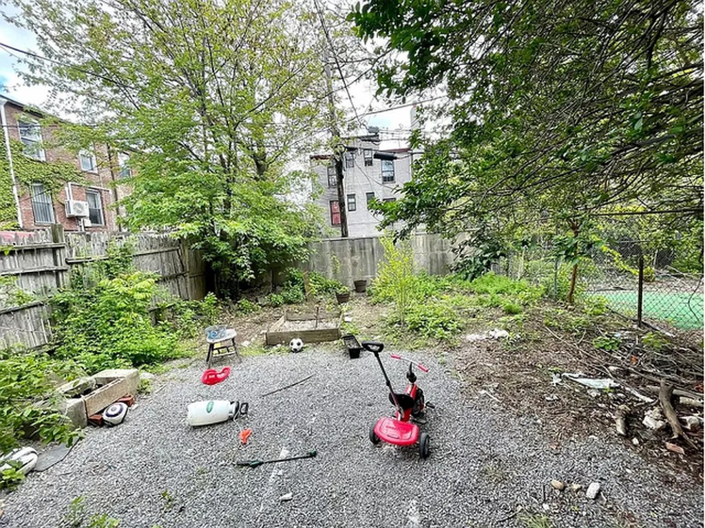 a backyard of a house with table and chairs