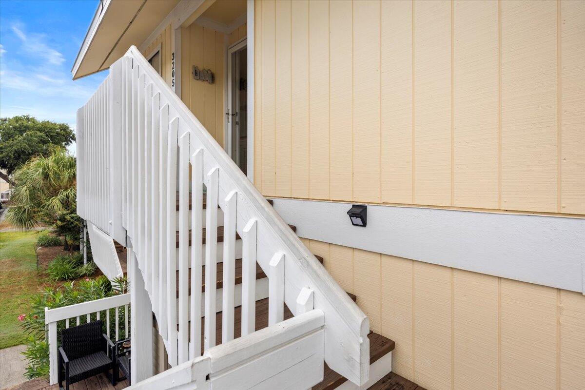 a view of staircase with railing and white walls