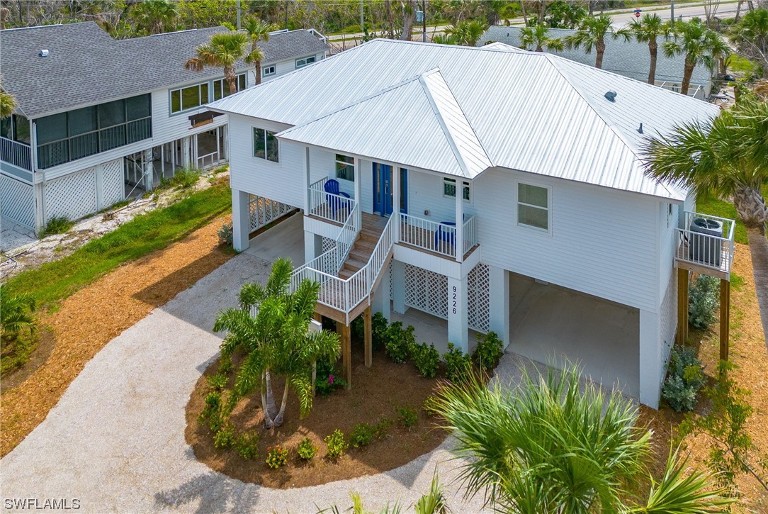 a aerial view of a house with a yard and potted plants