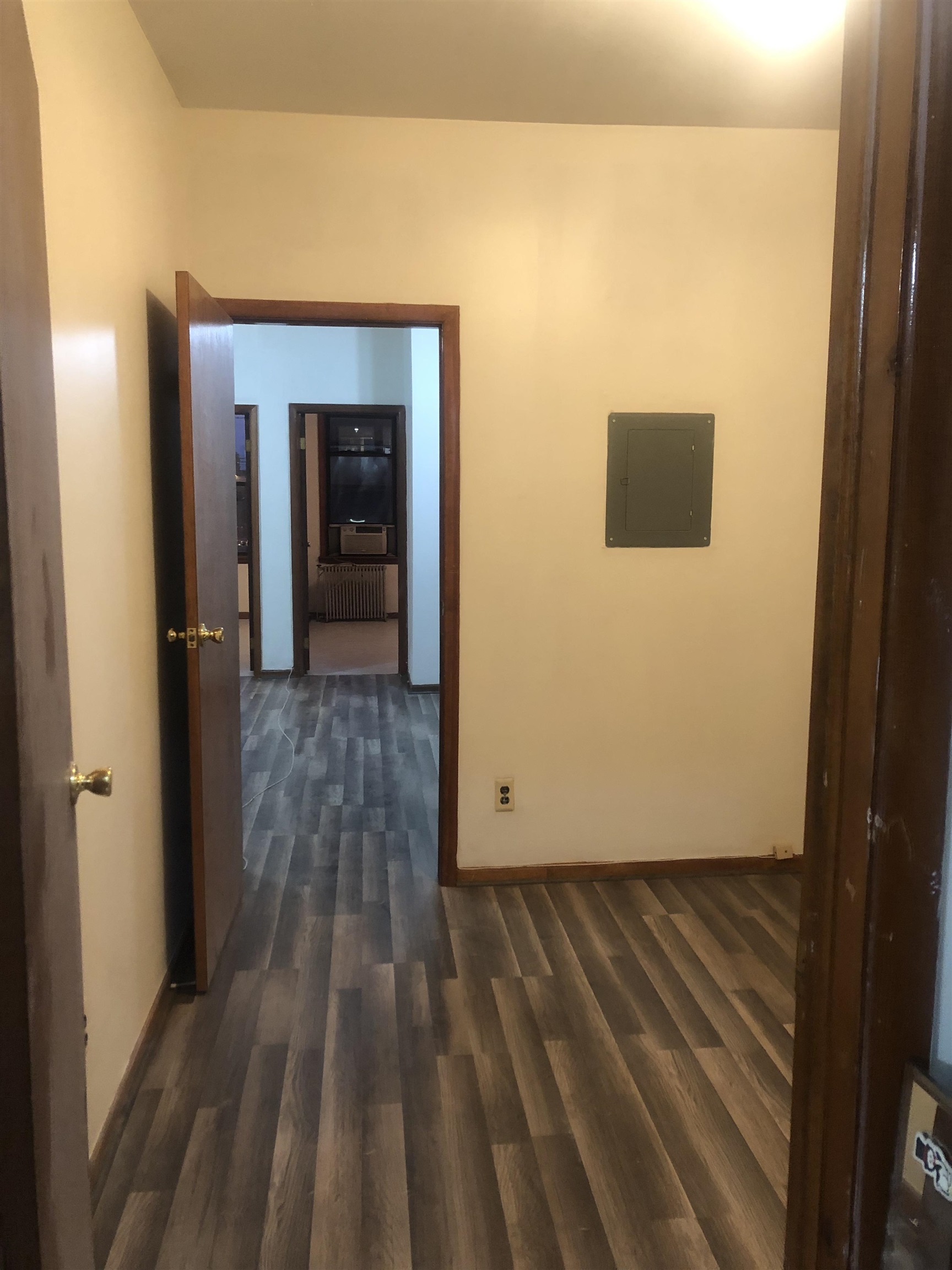 a view of a hallway with wooden floor