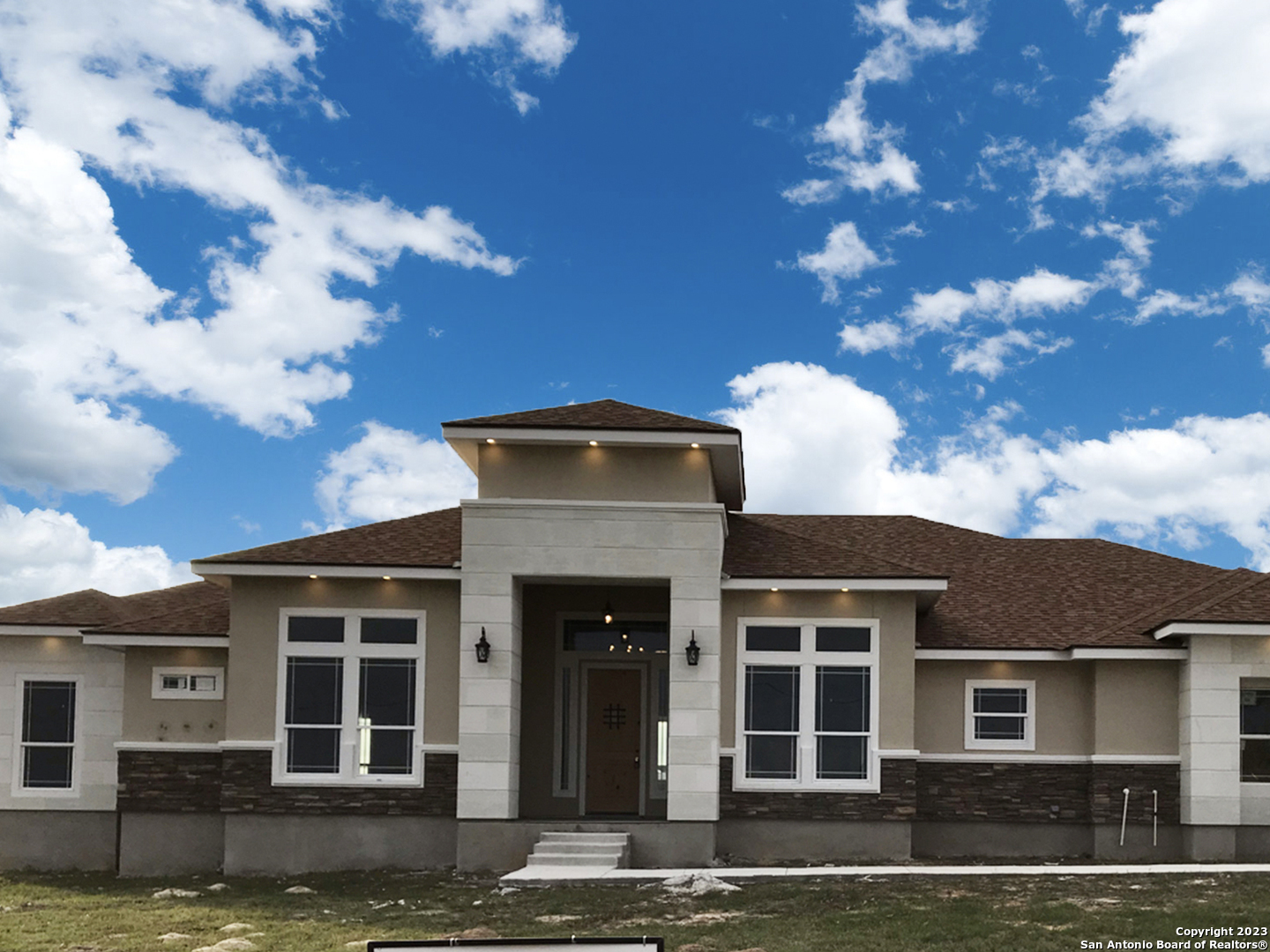 a front view of a house with garden