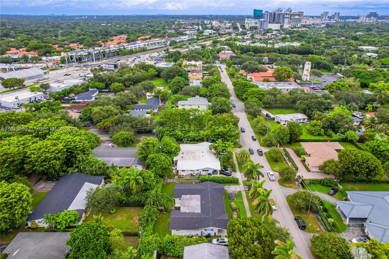 an aerial view of residential houses with outdoor space and parking