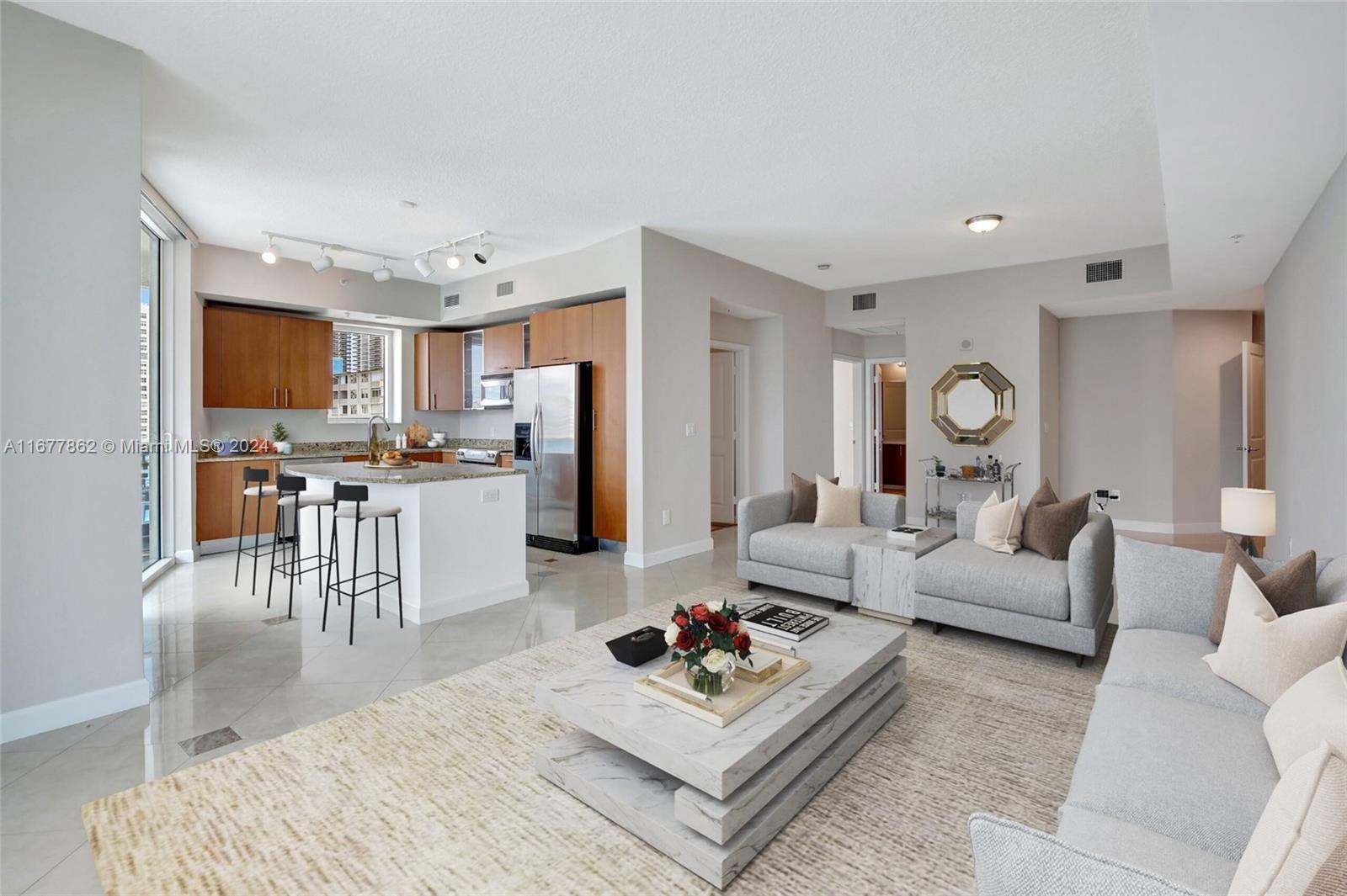 a living room with furniture and kitchen view