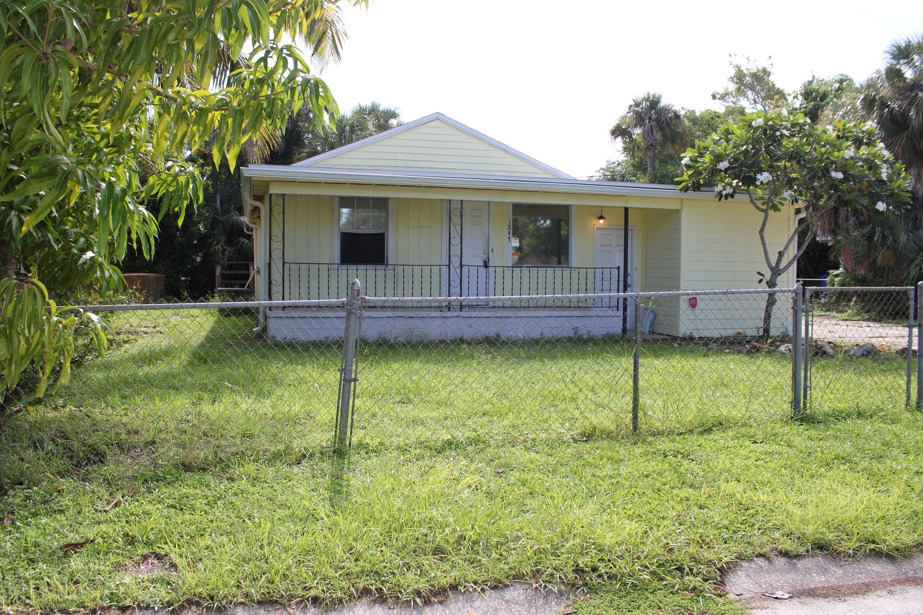 a view of a house with a backyard and a garden