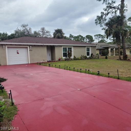 a view of a house with a yard and large tree