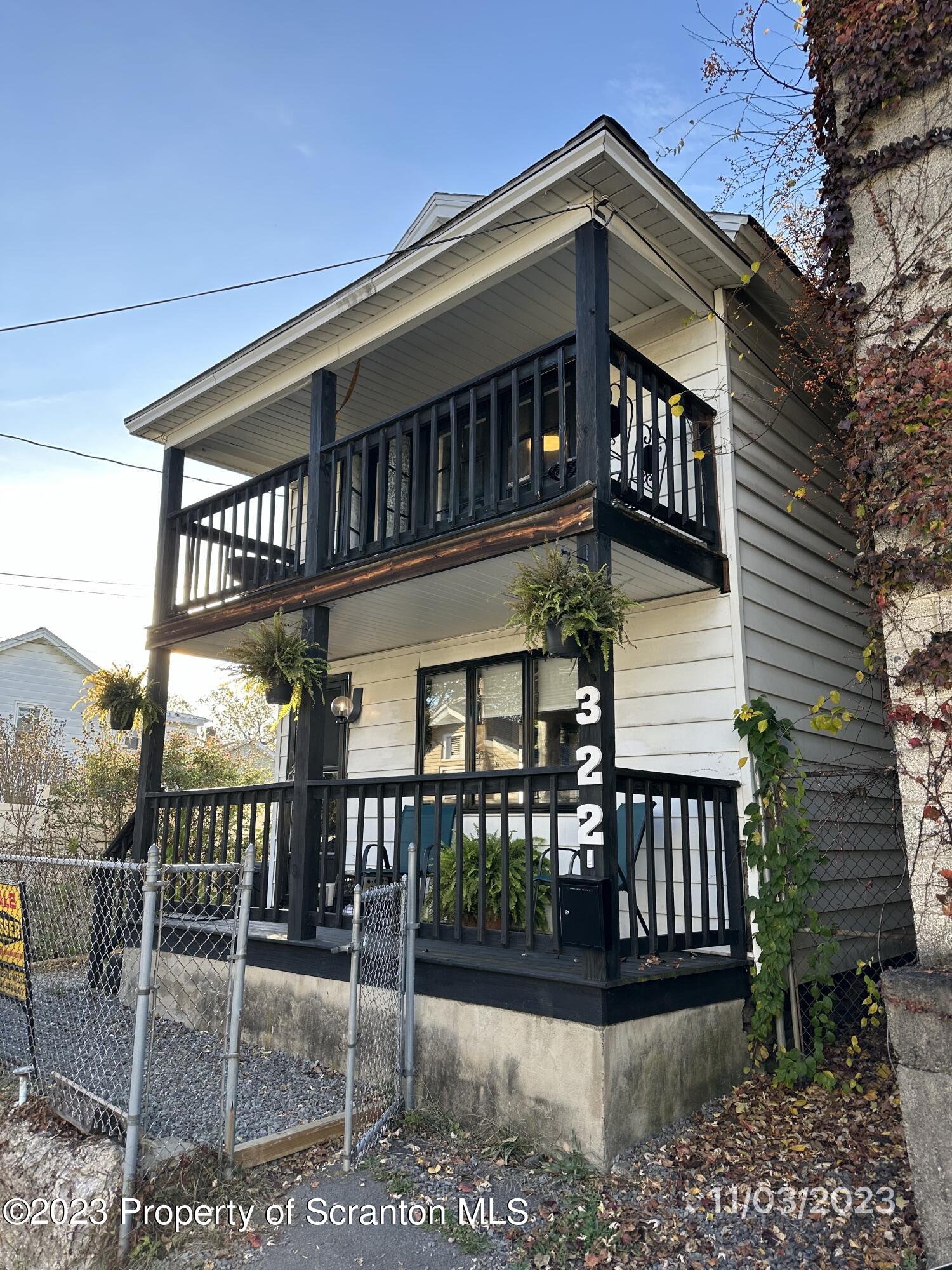 a view of a brick house with large windows and a table