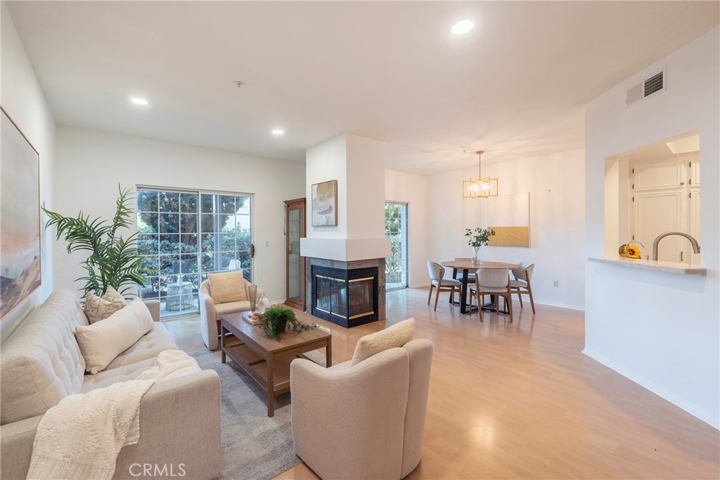 a living room with furniture a fireplace and a table