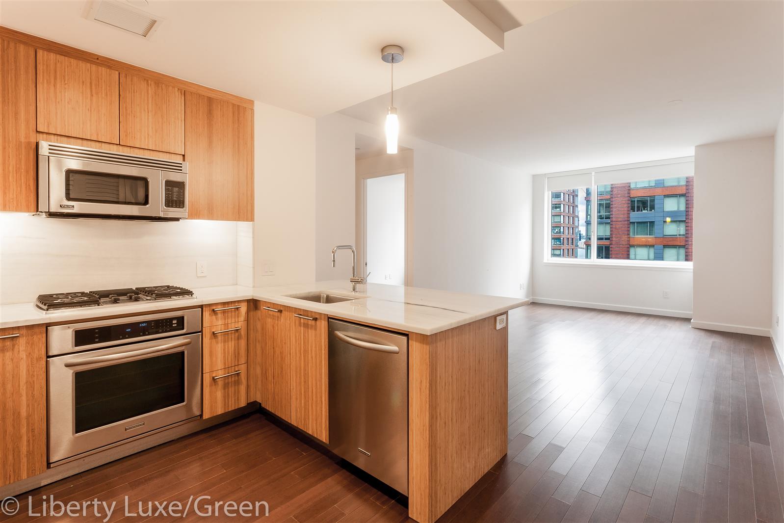 a kitchen with stainless steel appliances granite countertop a stove a microwave and a refrigerator