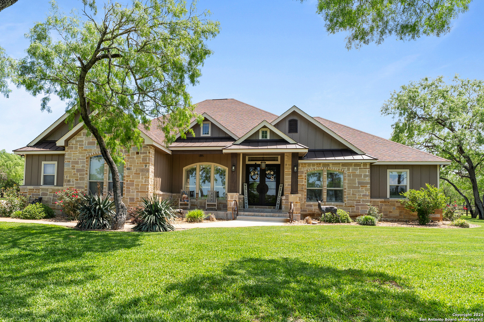 a front view of house with yard and green space