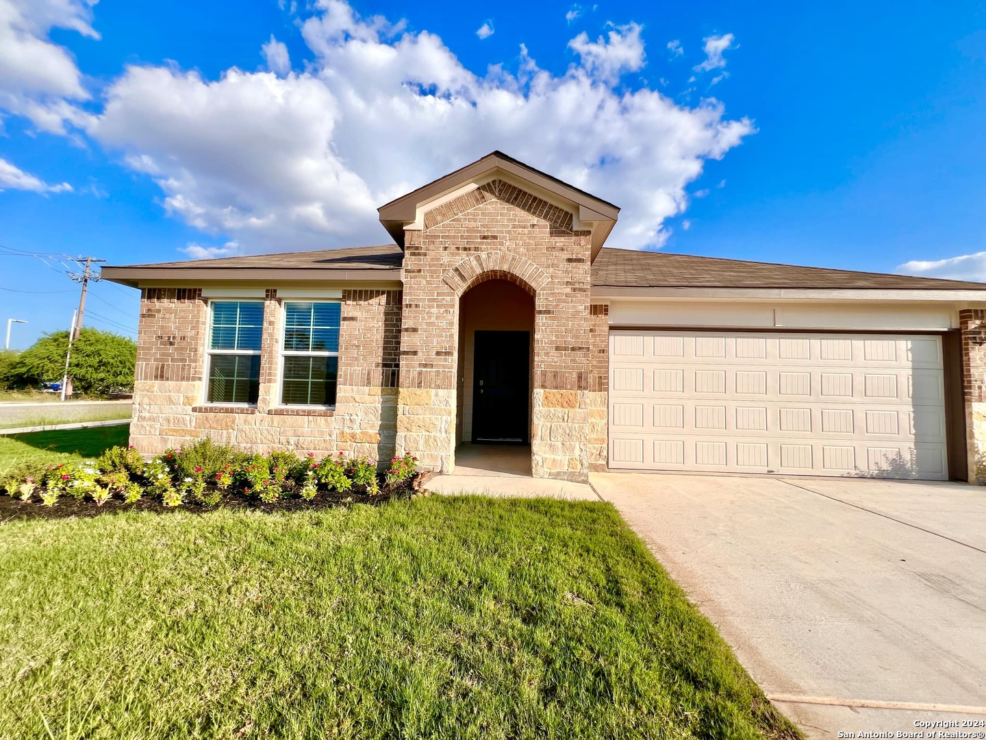 a front view of a house with a big yard