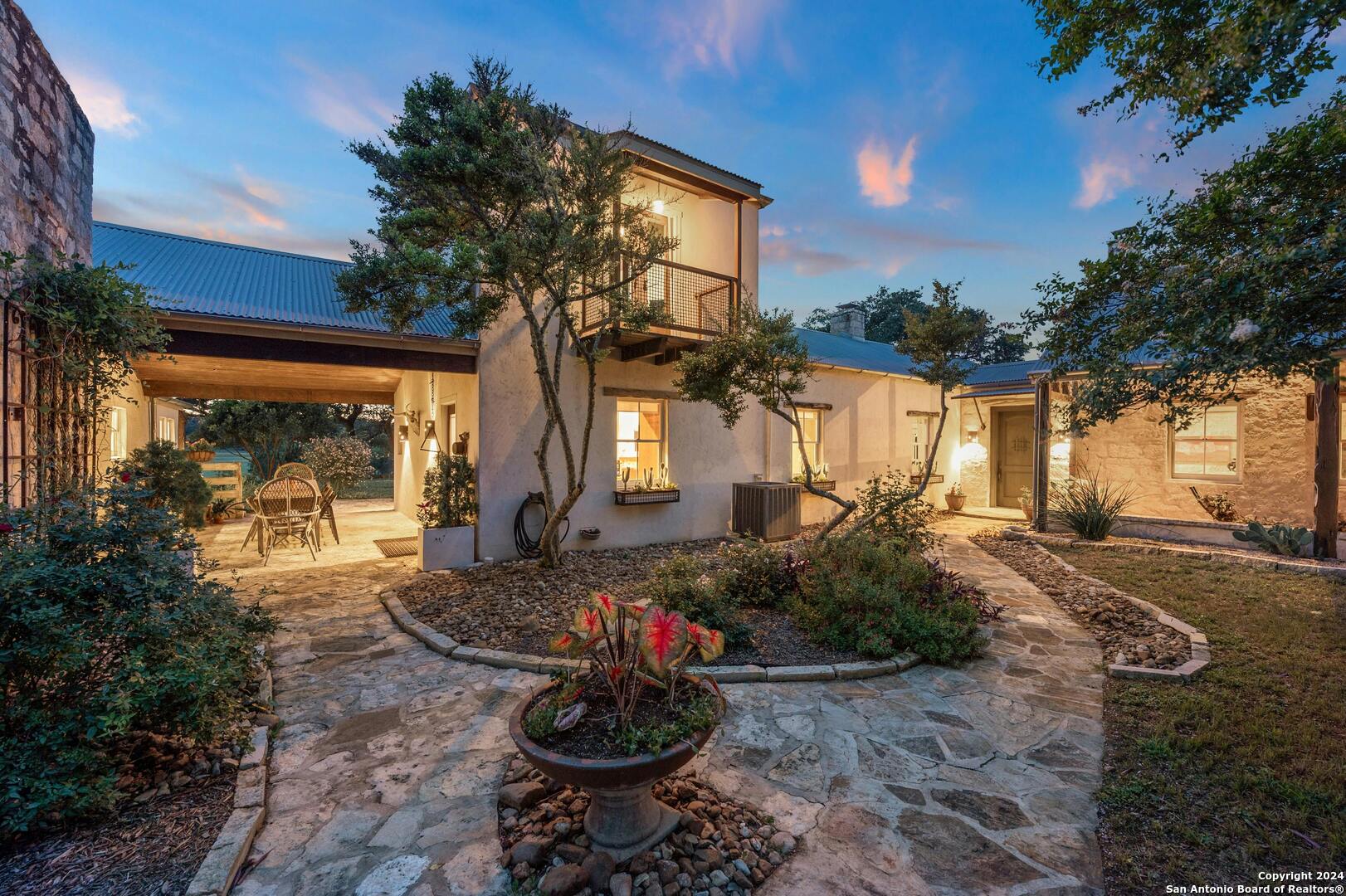 a view of a house with backyard and sitting area