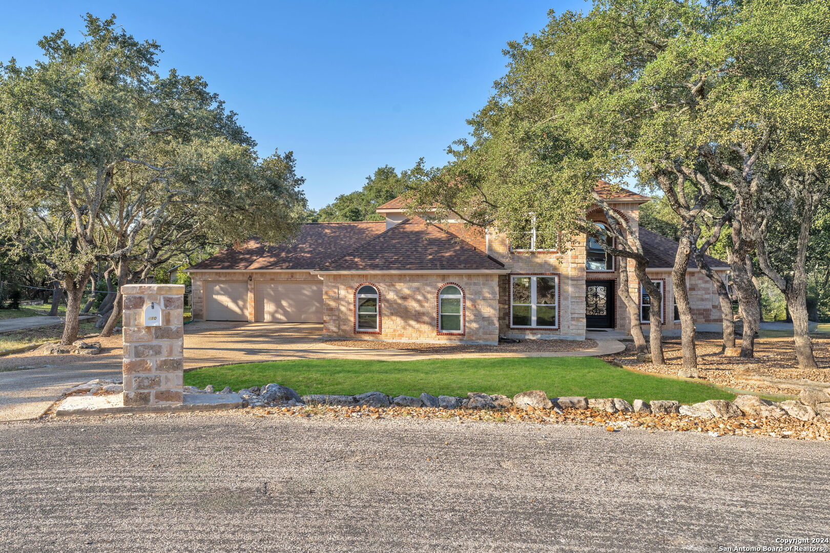 a front view of house with yard and green space