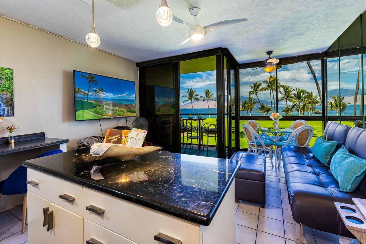 a kitchen with stainless steel appliances granite countertop a sink a stove and a wooden cabinets