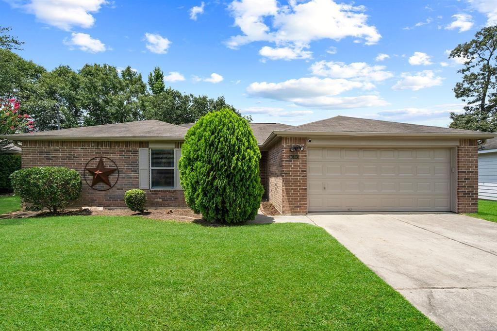 a front view of a house with a garden and yard