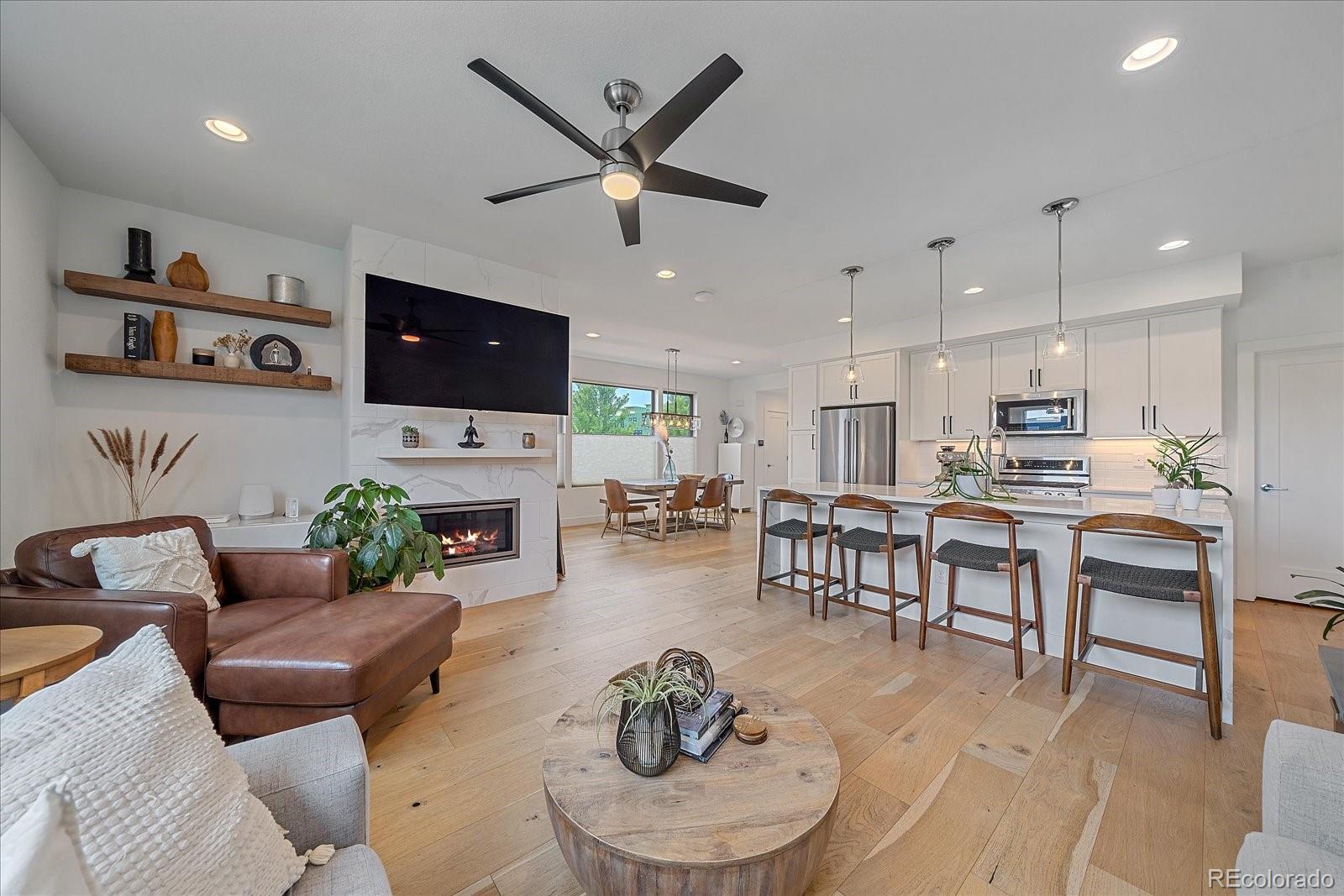 a living room with fireplace furniture and a flat screen tv