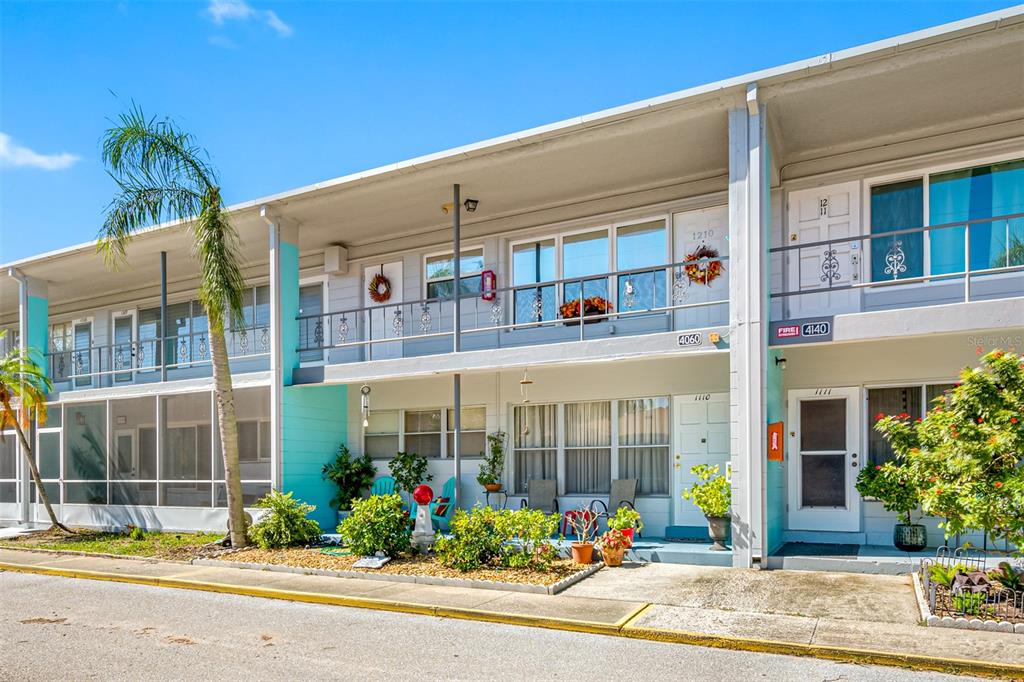 a front view of multi story residential apartment building with yard