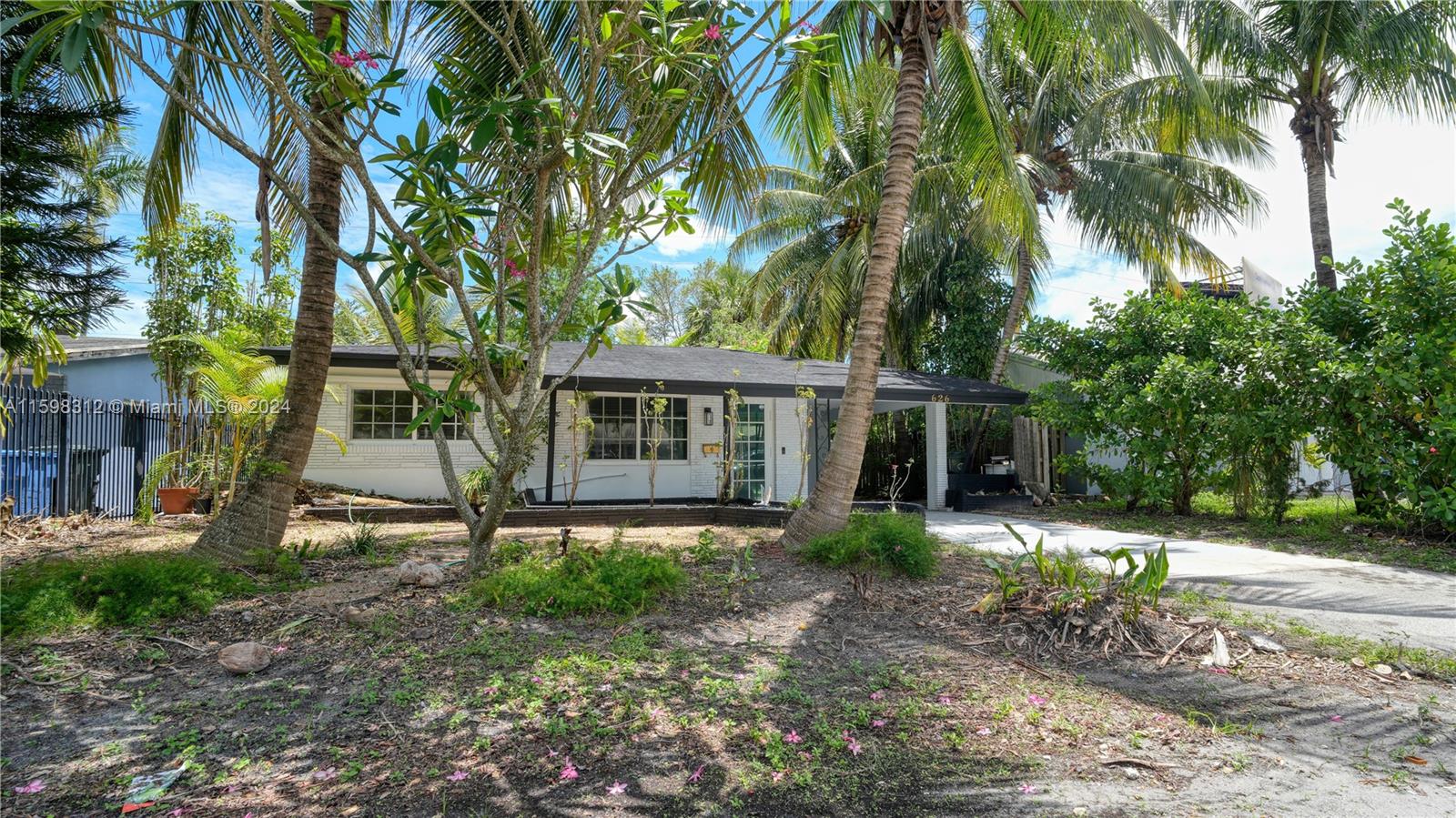 a view of a house with a tree in front