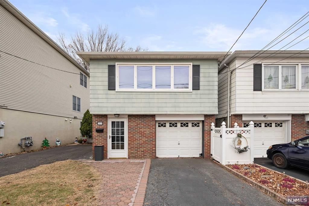 a view of a house with a yard and garage