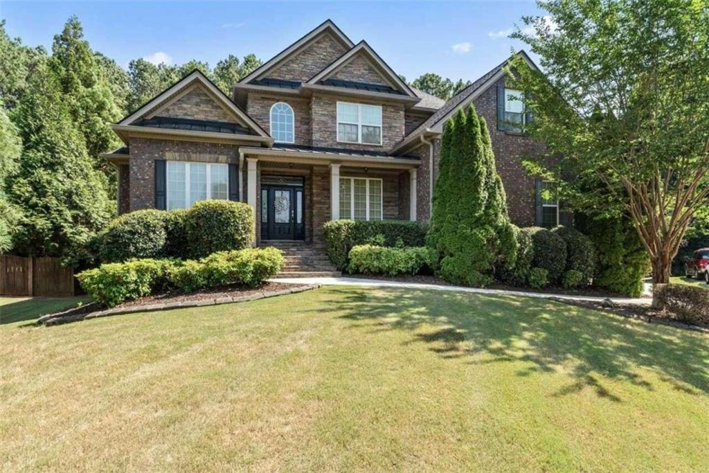 a front view of a house with a yard