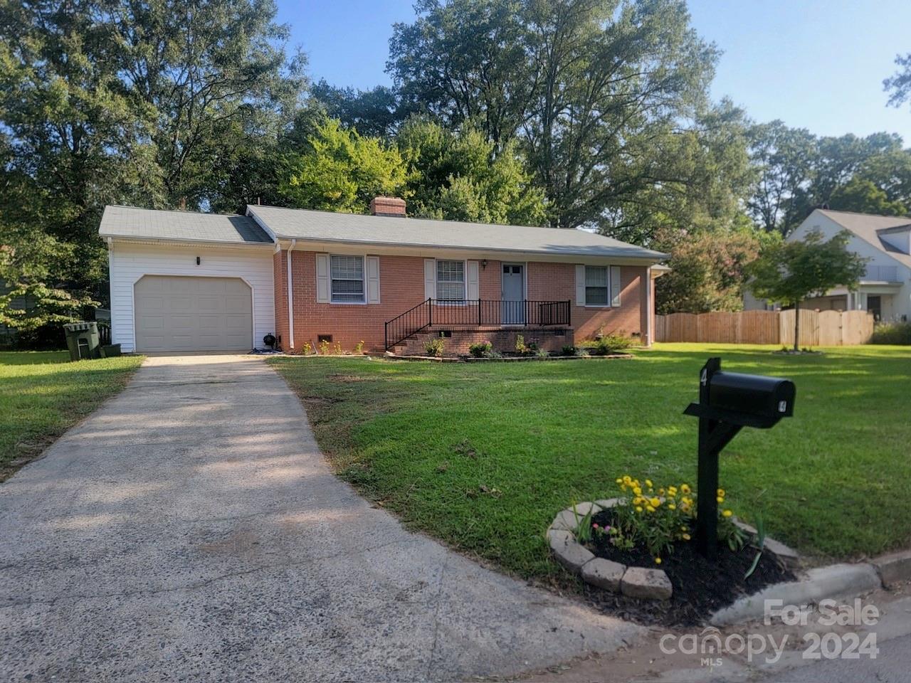 a front view of house with a garden and patio