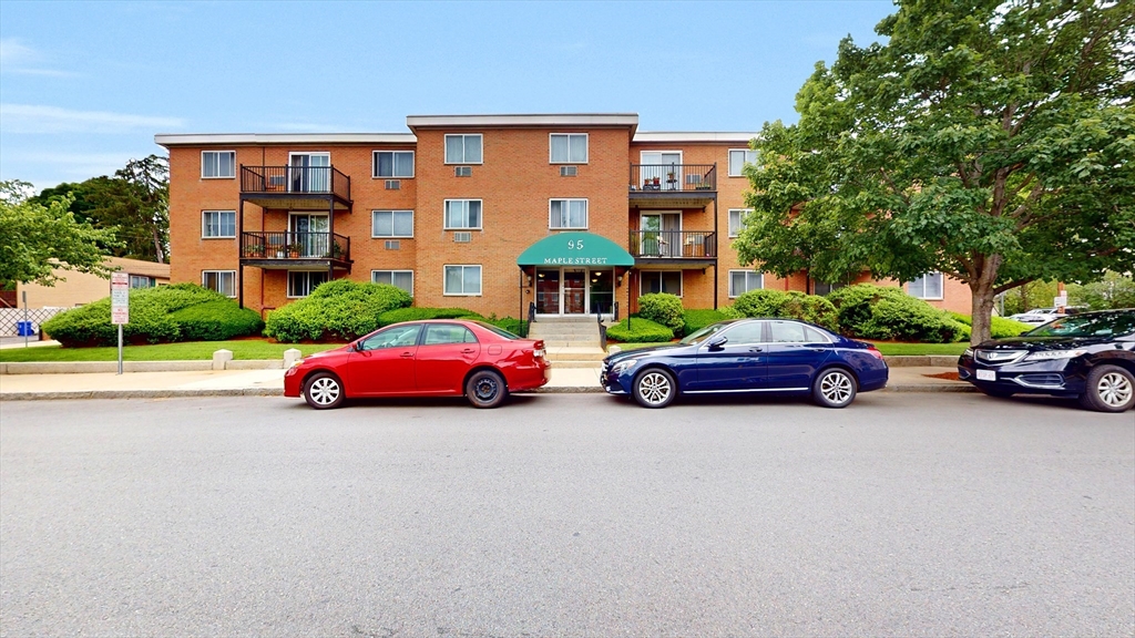 a view of cars parked in front of a building