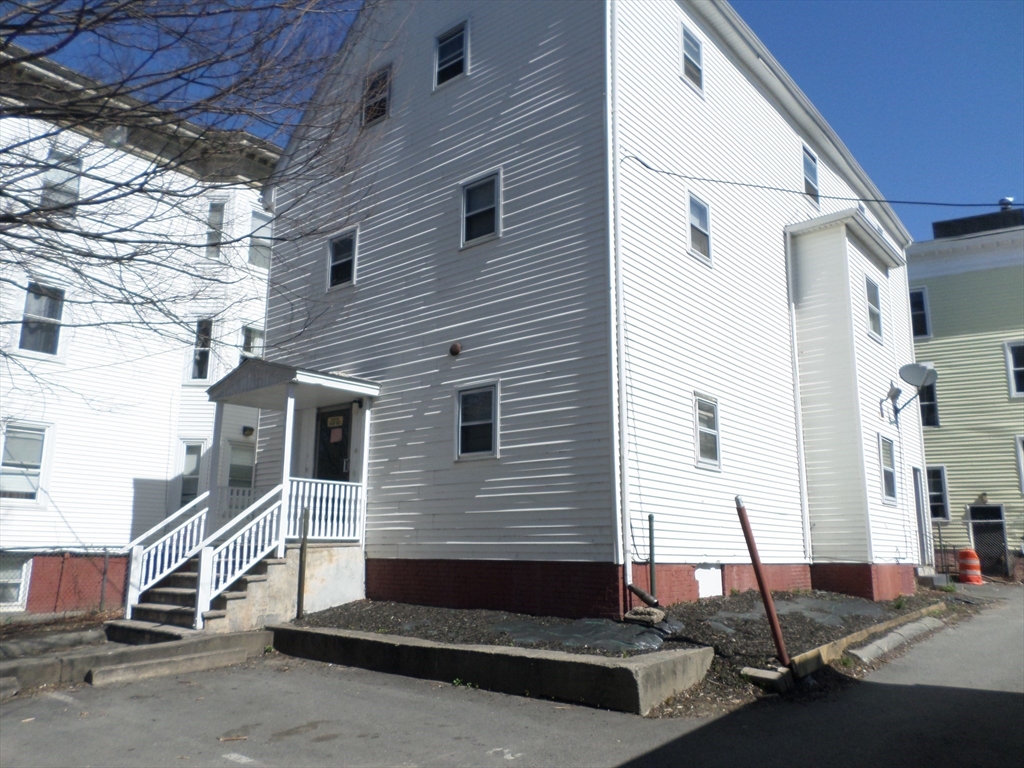 a front view of a house with a street