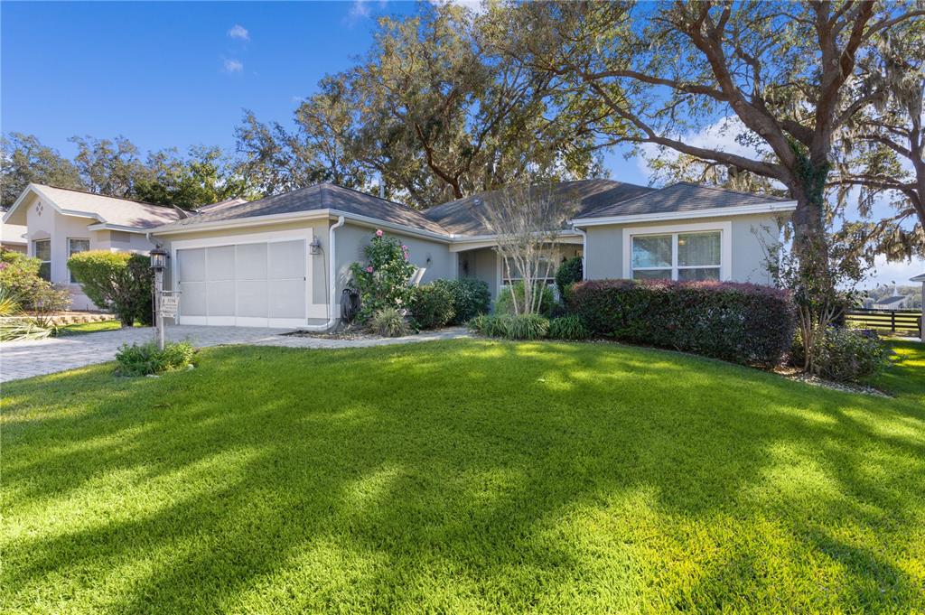 a front view of house with yard and green space