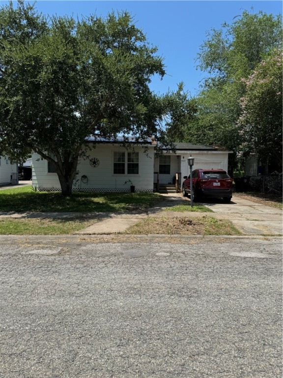 a view of house with outdoor space and car parked