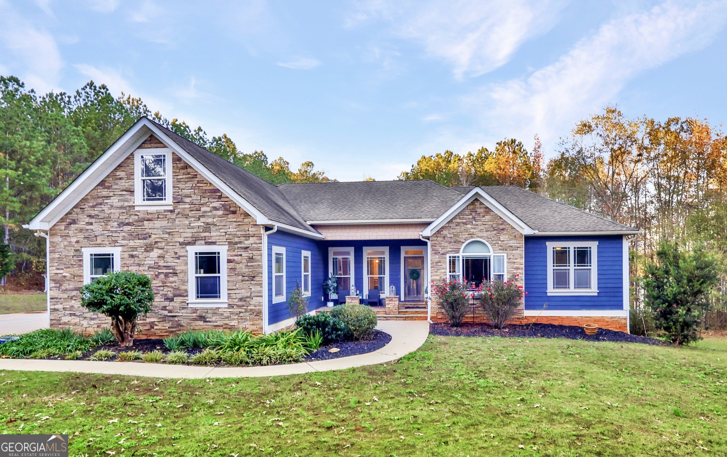 a front view of a house with garden