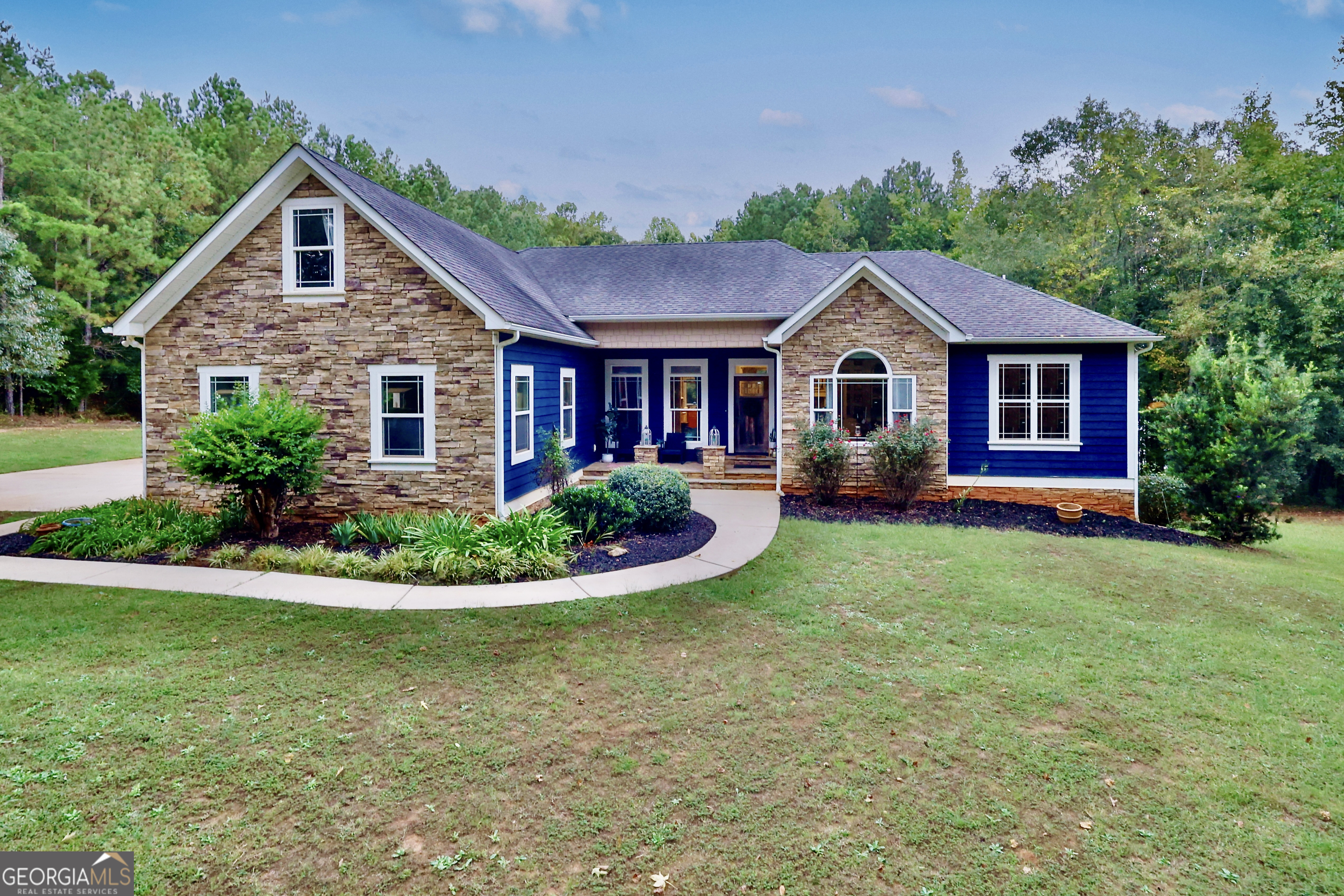 a front view of house with yard and green space