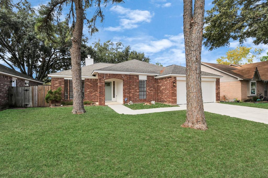 a front view of a house with yard and green space