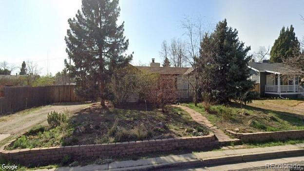 a view of a backyard with wooden fence