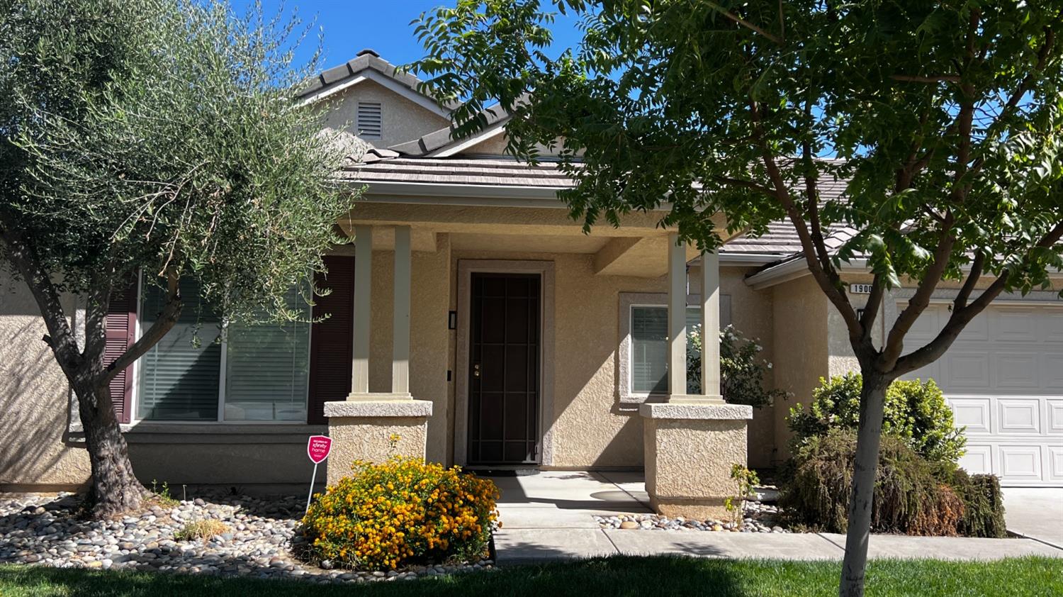 a front view of a house with garden