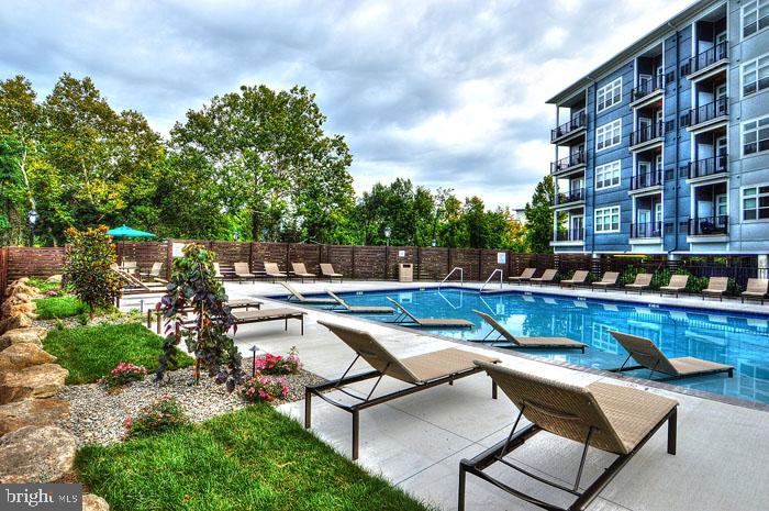 a view of swimming pool with outdoor seating and plants