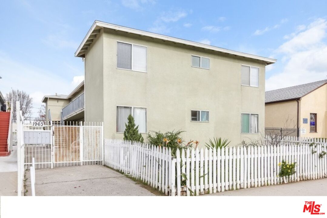 a front view of a house with wooden fence