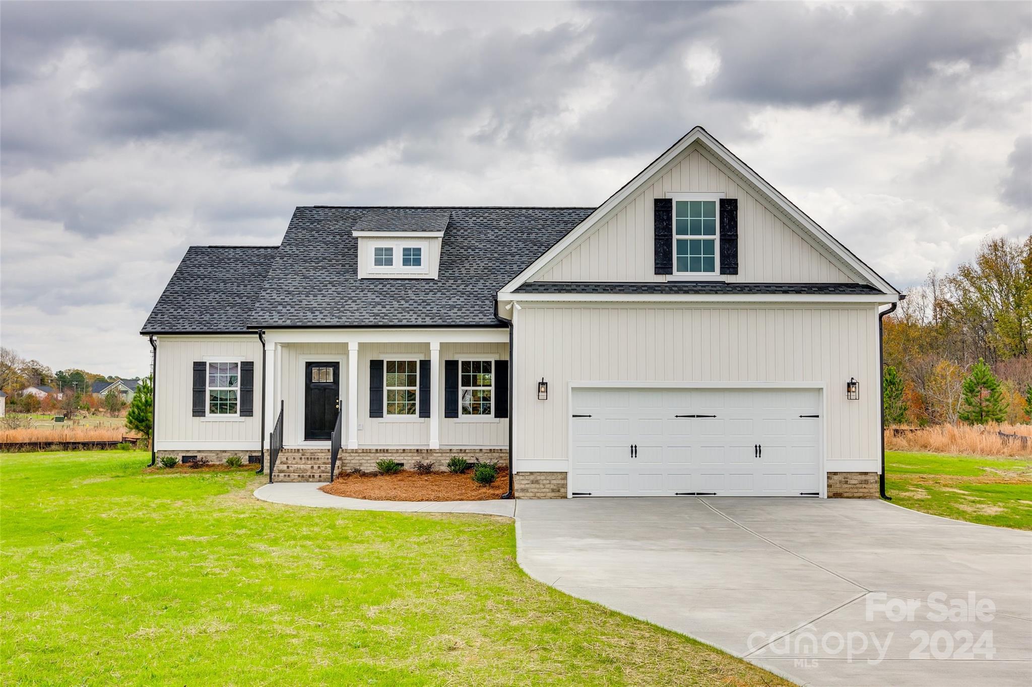 a front view of house with yard and garage