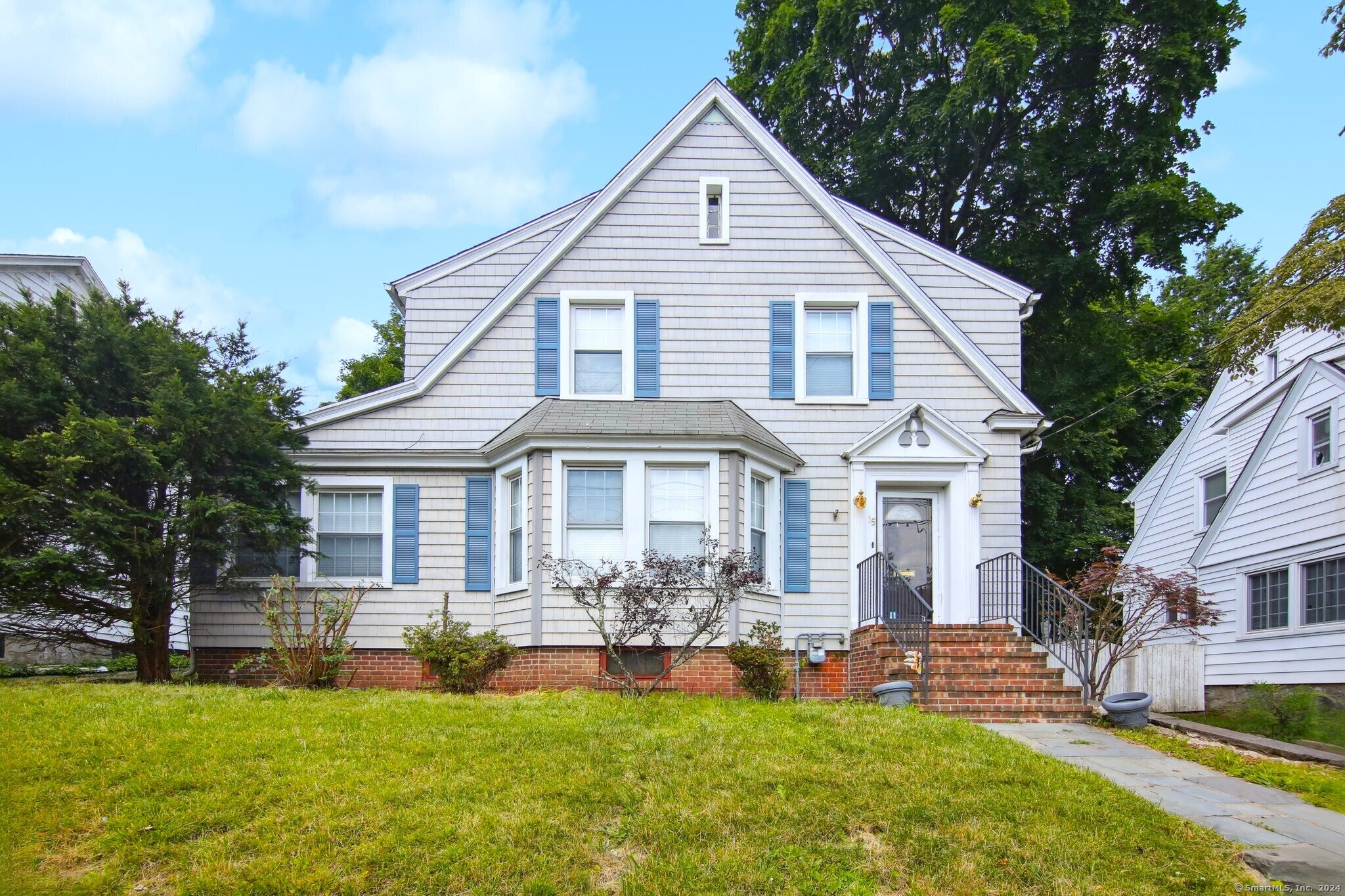 a front view of a house with a garden and patio