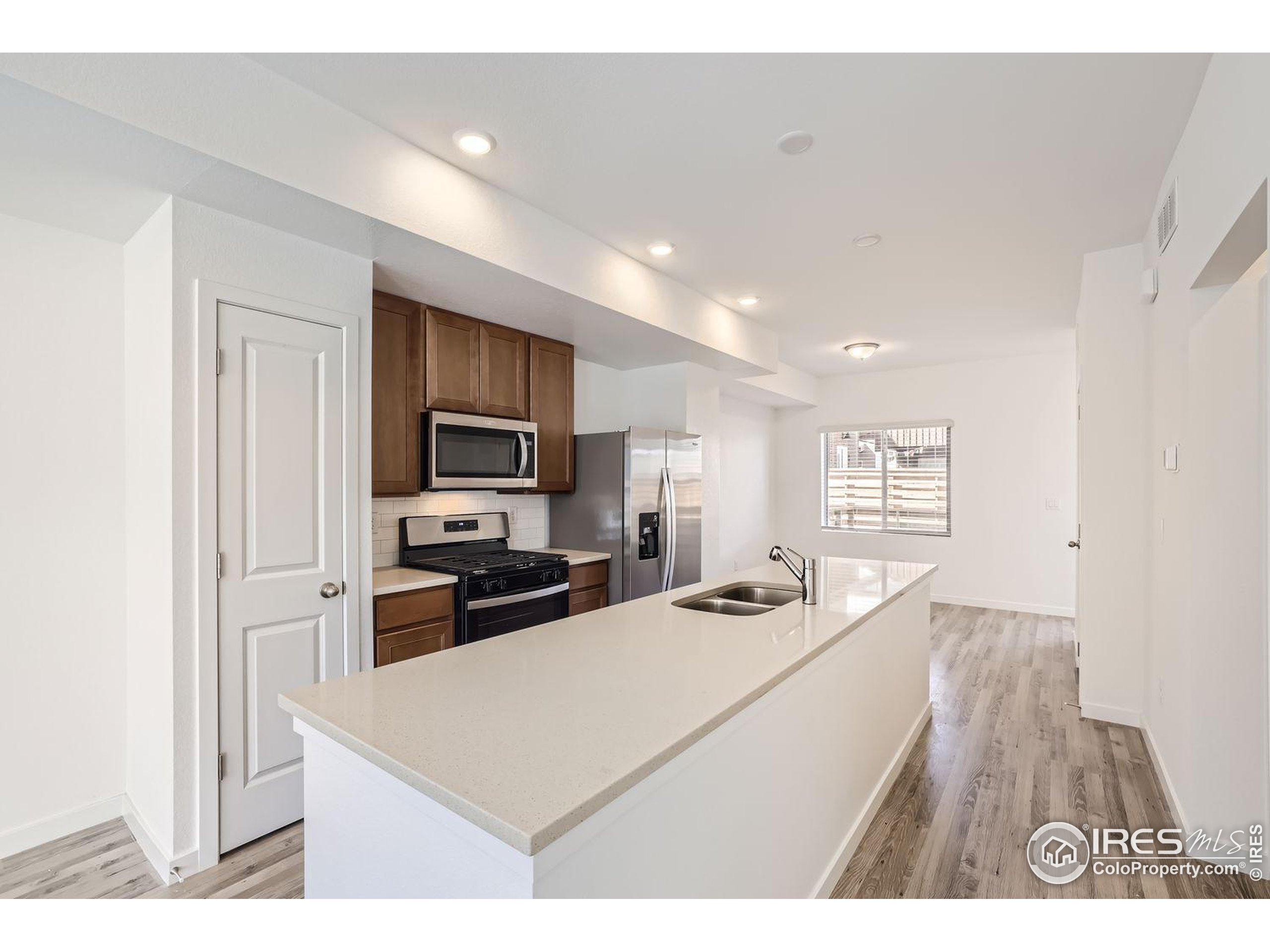 a kitchen with stainless steel appliances kitchen island granite countertop a stove sink and cabinets