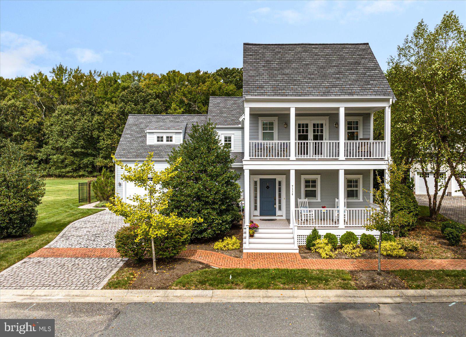 a front view of a house with a garden and plants