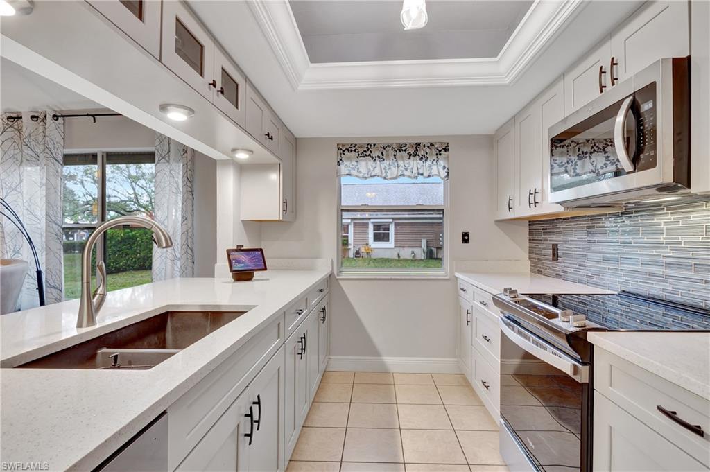 a kitchen that has a sink and a stove