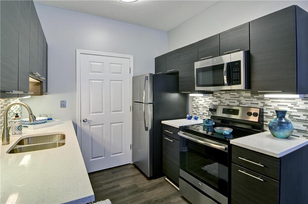 a kitchen with a stove microwave and refrigerator